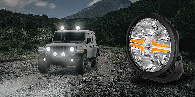 HELLA X-Treme Series IP69K LED Driving Lights in amber X-shape mode, auxiliary high-beam on SUV roof rack, off-road