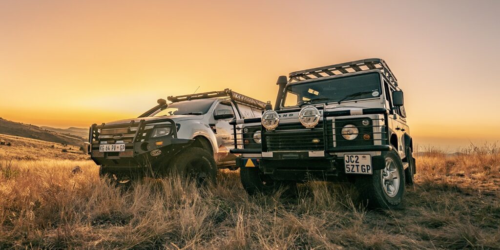 Off-road SUVs with HELLA X-Treme Series LED Driving Lights in white mode, X-shape position light, IP69K, bumper-mounted auxiliary high-beam.