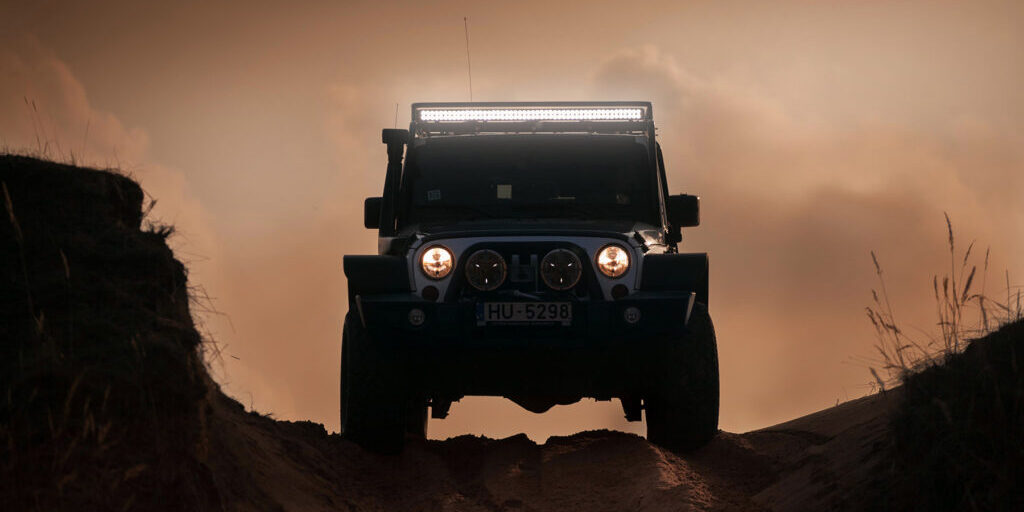 Off-road SUV with HELLA X-Treme Series LED Driving Lights, IP69K, roof rack auxiliary high-beam, X-shape position light in white mode
