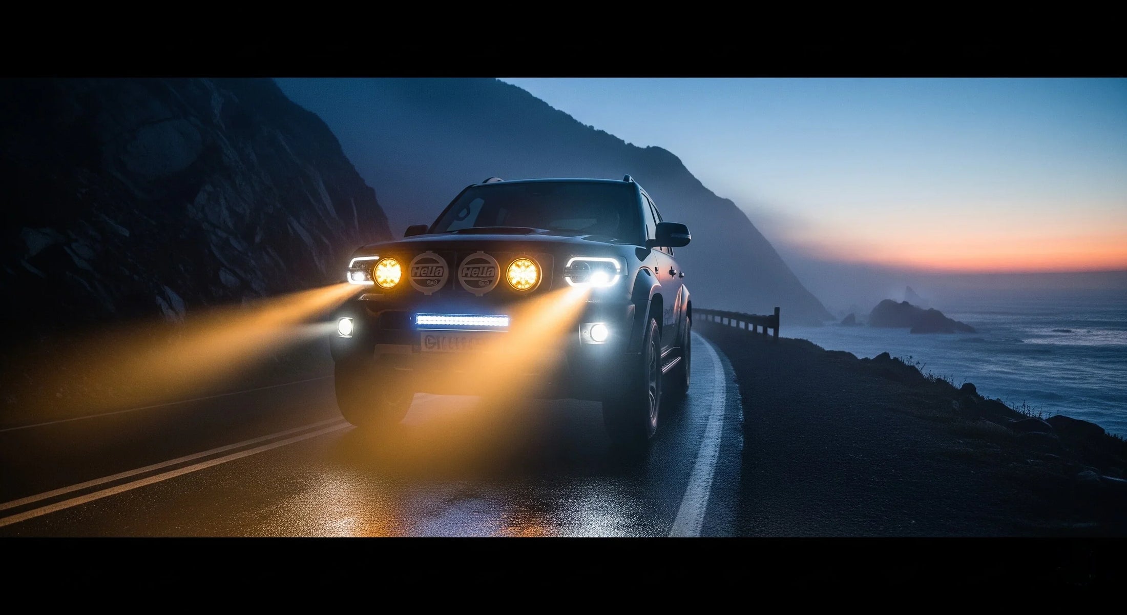 Truck with HELLA X-Treme Series LED Driving Lights in Amber mode, X-shape position light, IP69K auxiliary high-beam, off-road bumper mount at dusk.