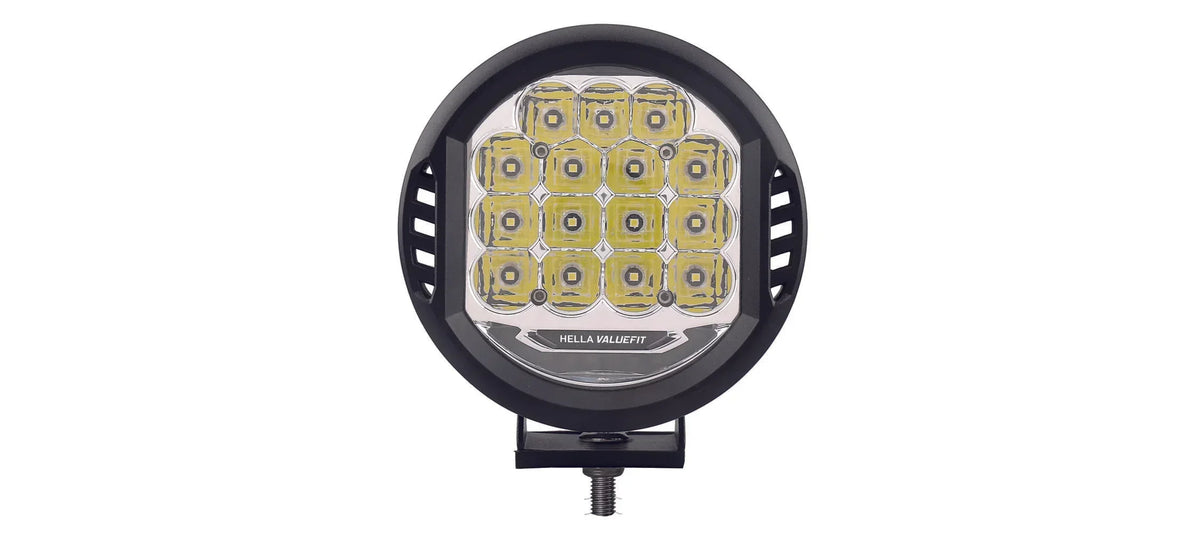 HELLA X-Treme Series LED Driving Lights in white mode with X-shape position light, rugged aluminum housing, IP69K rated, auxiliary high-beam, off-road ready.