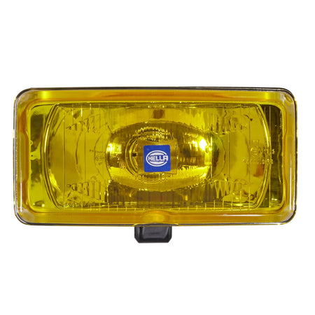 HELLA X-Treme Series LED Driving Light in amber mode with X-shape position light, IP69K rated, auxiliary high-beam, rugged aluminum housing.