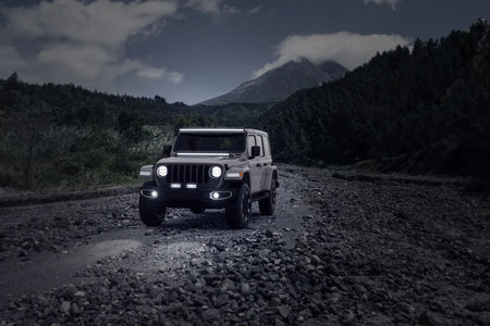 HELLA Black Magic Tough Slim Curved Lightbar 30" — off-road SUV with bumper and roof rack mounted lightbars