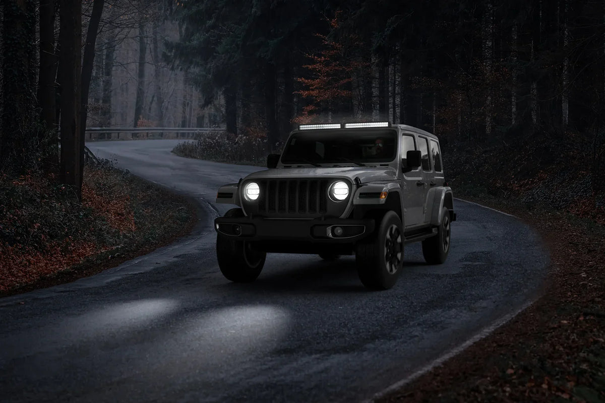 SUV with HELLA X-Treme Series LED Driving Lights in white mode, X-shape position light, IP69K, roof-mounted auxiliary high-beam for off-road adventure.