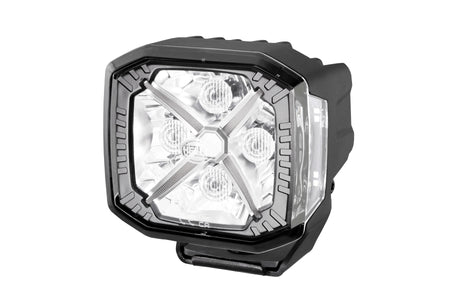 HELLA X-Treme Series LED Driving Lights in white mode with X-shape position light, rugged aluminum housing, IP69K, off-road auxiliary high-beam.
