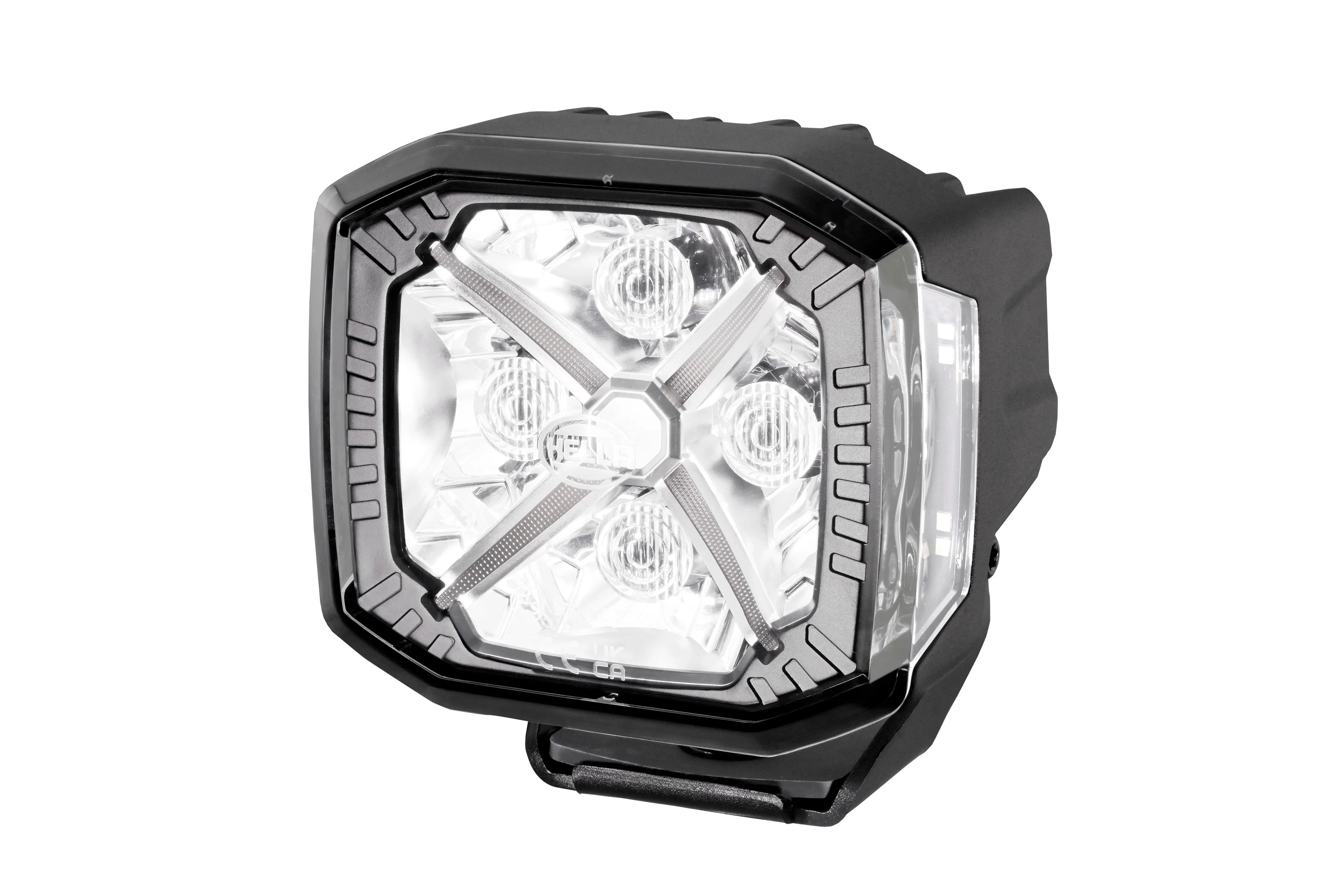 HELLA X-Treme Series LED Driving Light in white mode, showing X-shape position light, IP69K-rated rugged aluminum housing, auxiliary high-beam, off-road use.