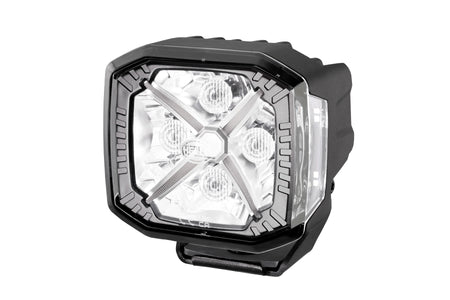 HELLA X-Treme Series LED Driving Light in white mode, showing X-shape position light, IP69K-rated rugged aluminum housing, auxiliary high-beam, off-road use.