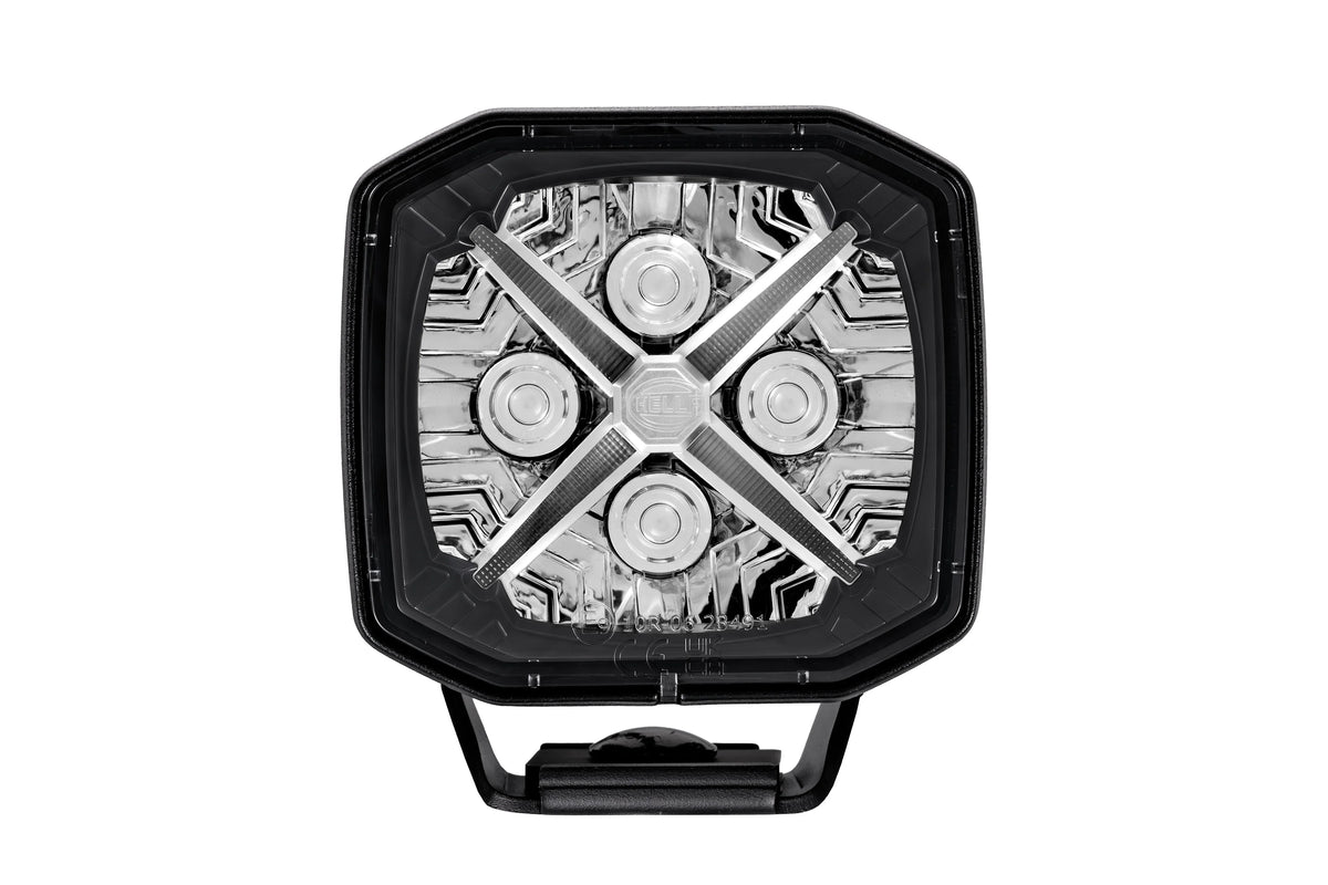 HELLA X-Treme Series LED Driving Lights in white mode, clear lens, X-shape position light, rugged aluminum build, IP69K rated, auxiliary high-beam for off-road
