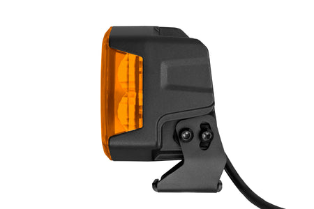HELLA X-Treme Series LED Driving Lights in amber mode, rugged aluminum housing, X-shape position light, IP69K auxiliary high-beam, off-road ready.