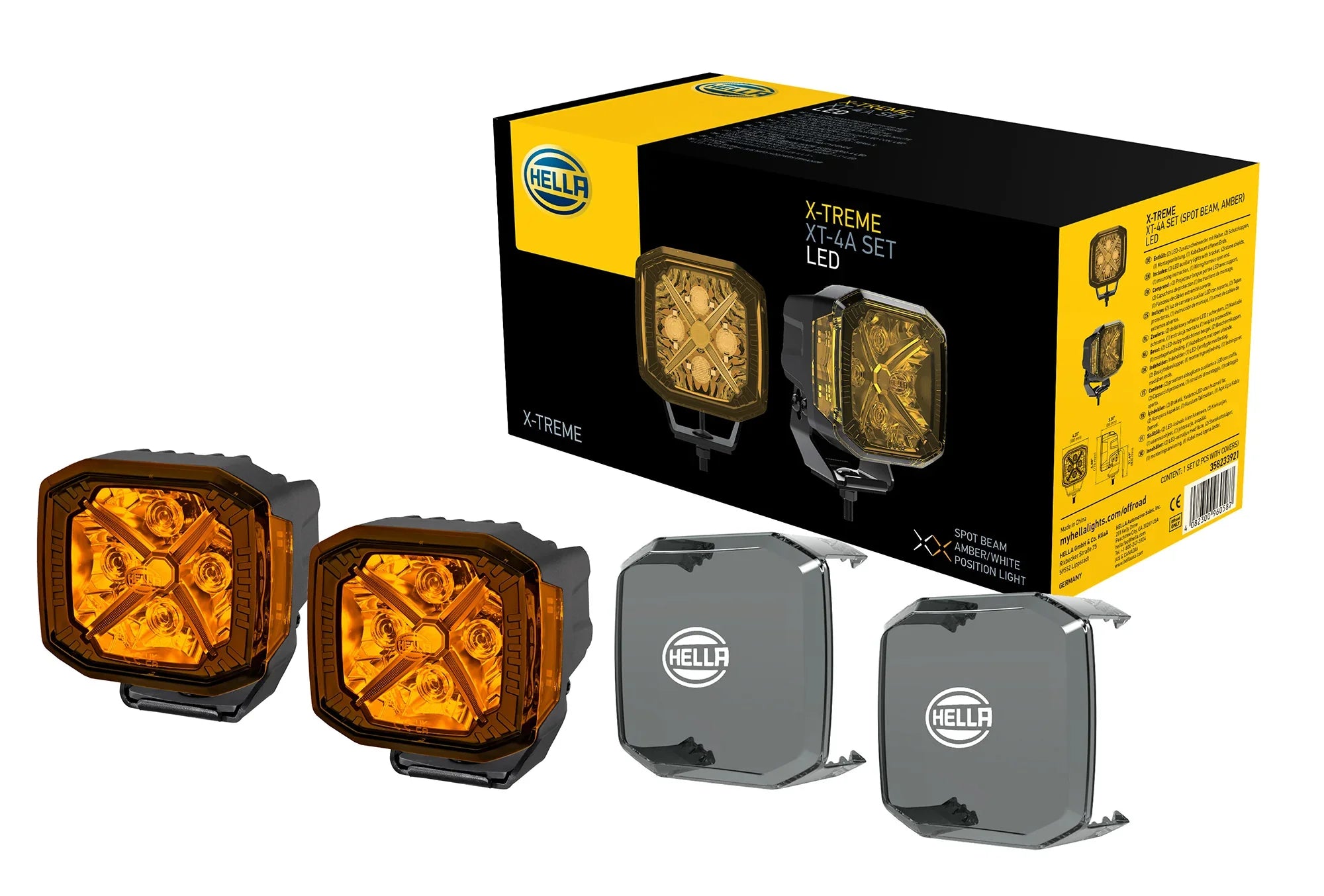 HELLA X-Treme Series LED Driving Lights in amber mode with X-shape position light, IP69K, auxiliary high-beam, rugged aluminum housing, off-road ready.
