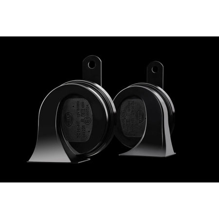 Two black HELLA TE20 trumpet electric twin-tone horns with glossy ABS plastic housing and metal brackets.