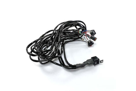 Black HELLA Performance Wiring Harness for 2 lights, coiled with weather-sealed connectors and integrated relay.