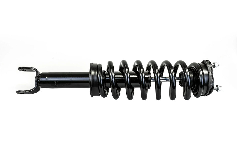 Black automotive suspension coil spring and shock absorber on white background