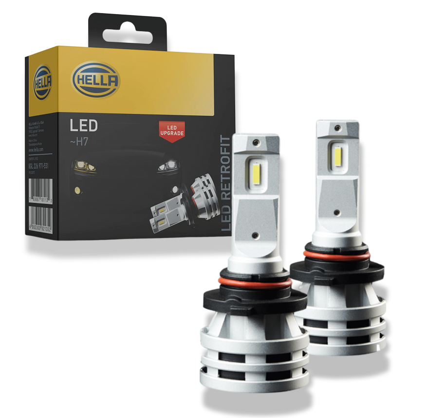 Two silver HELLA LED H7 retrofit fog light bulbs with black bases, next to their black and yellow product box.