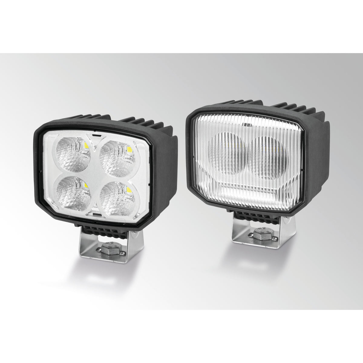 Two black Power Beam S LED work lamps, one with four clear lenses, the other with a patterned diffusing lens.