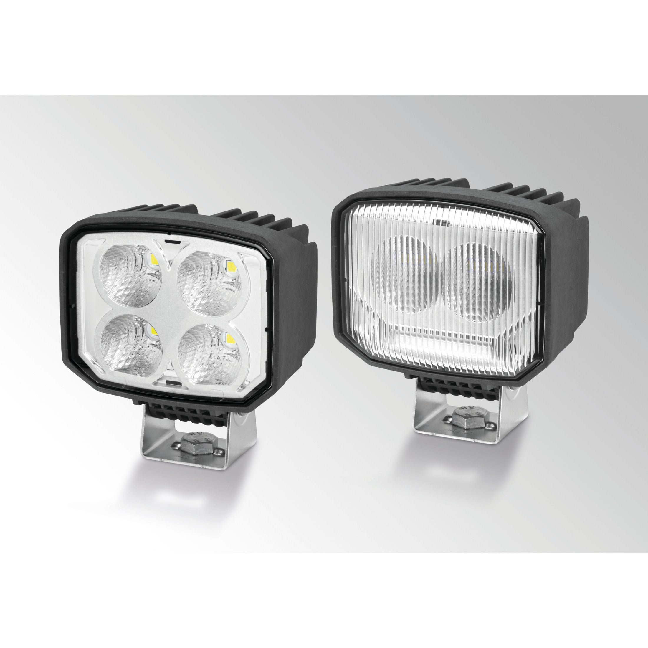 Two black Power Beam S LED work lamps, one with four clear lenses, the other with a patterned diffusing lens.